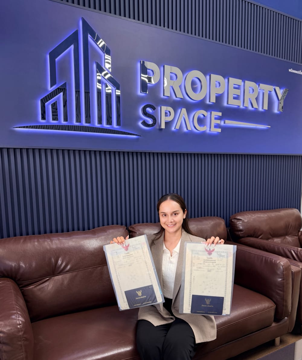 PropertySpace Client Purchase Success in Pattaya Jom holding chanote (title deed) at PropertySpace office in Pattaya, Thailand